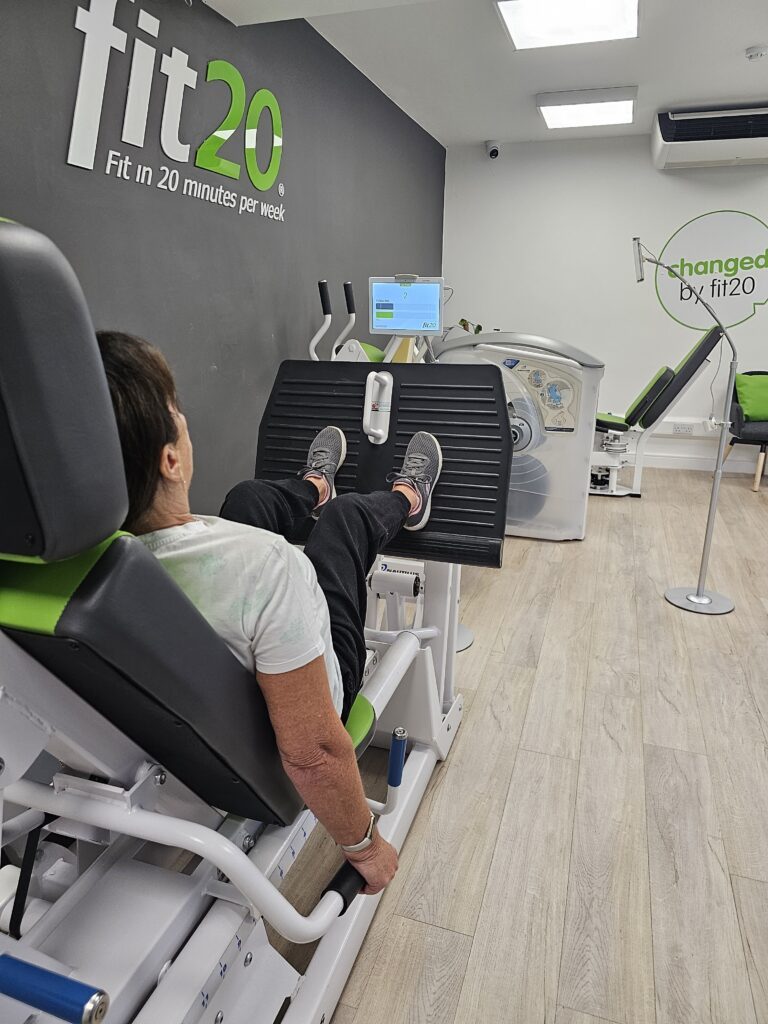 A member mid-rep on the fit20 leg press in the Birstall studio